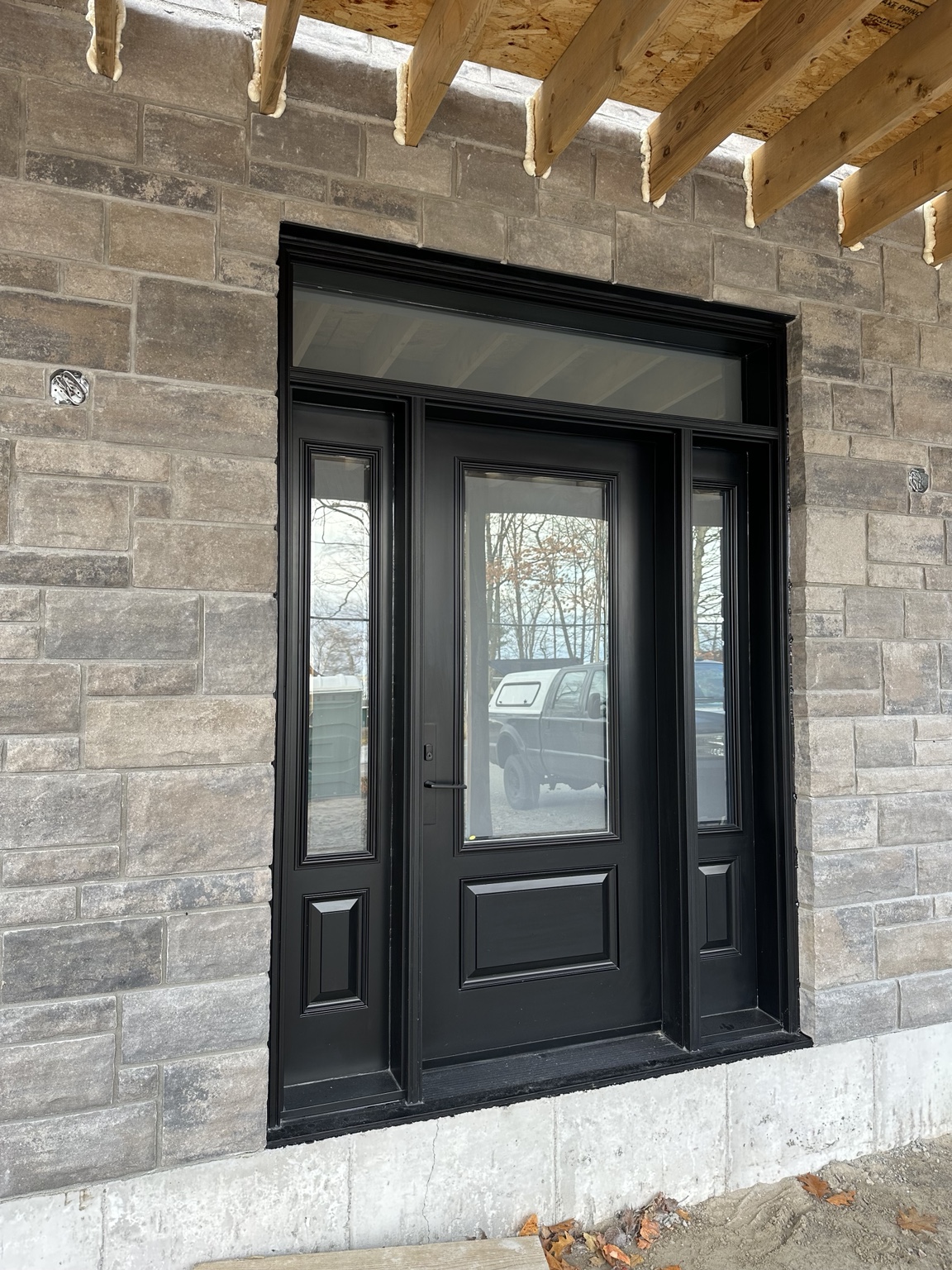 Black front entry door with sidelites